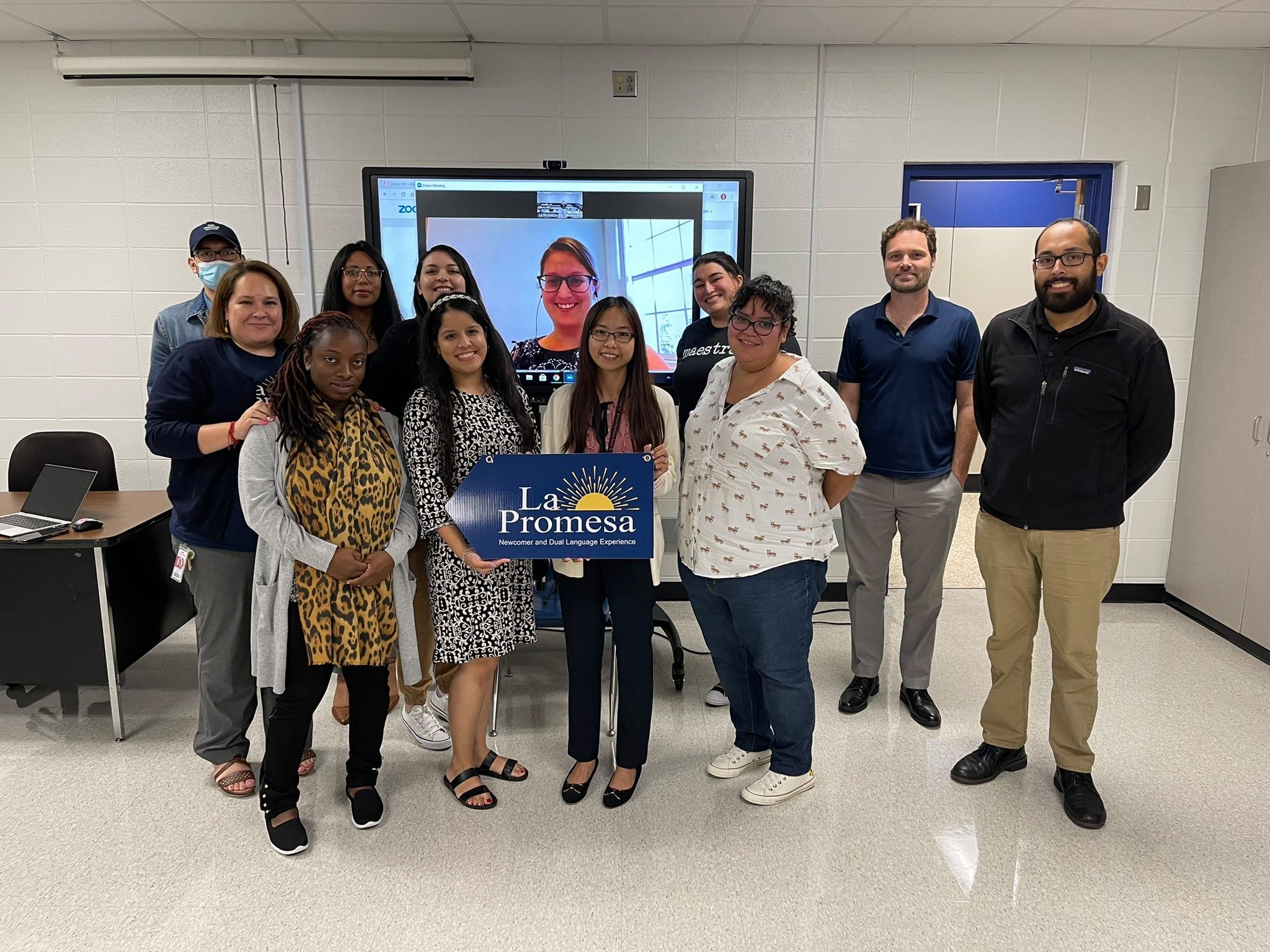 La Promesa students and teachers with school sign